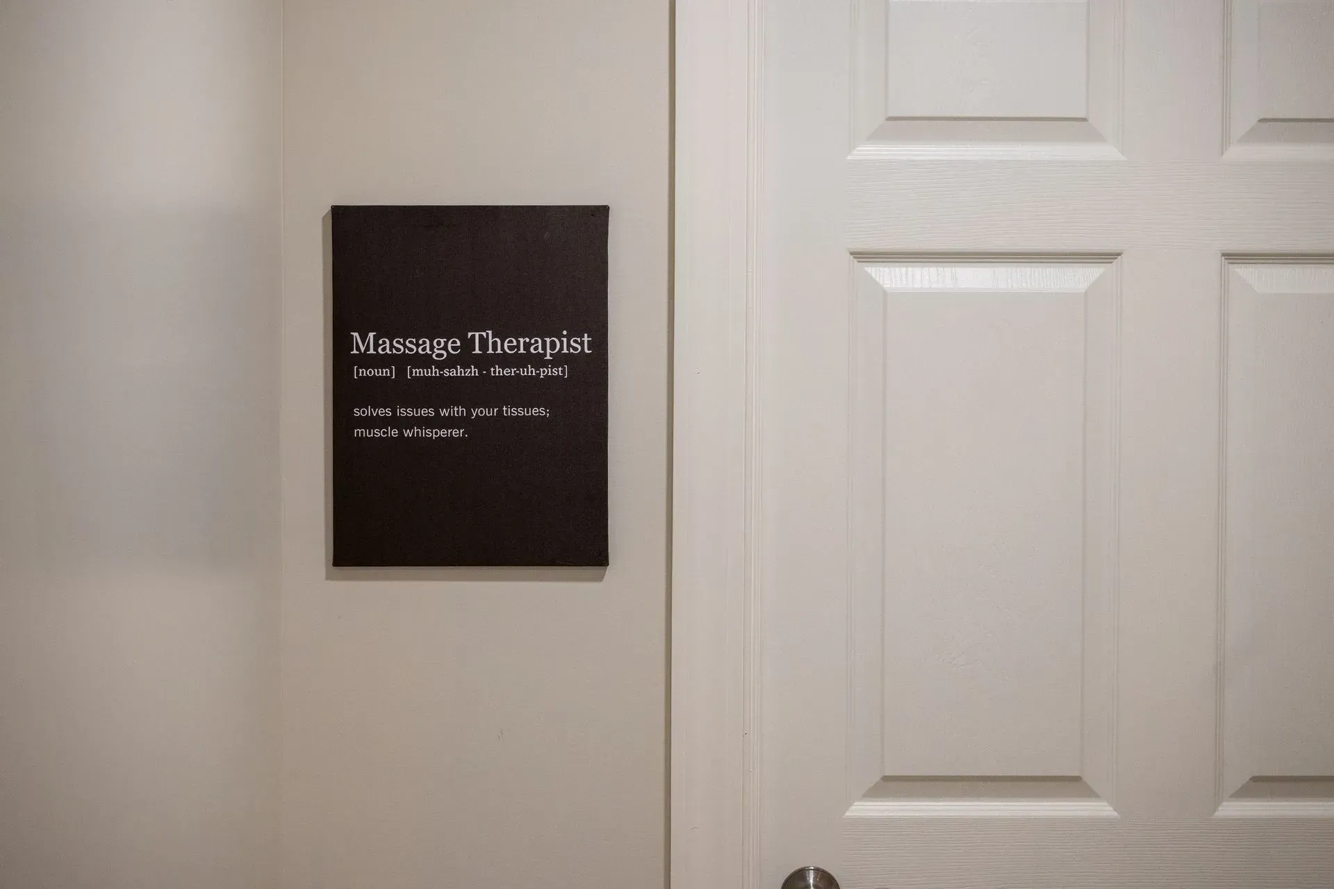 A door with a sign on it that says massage therapist