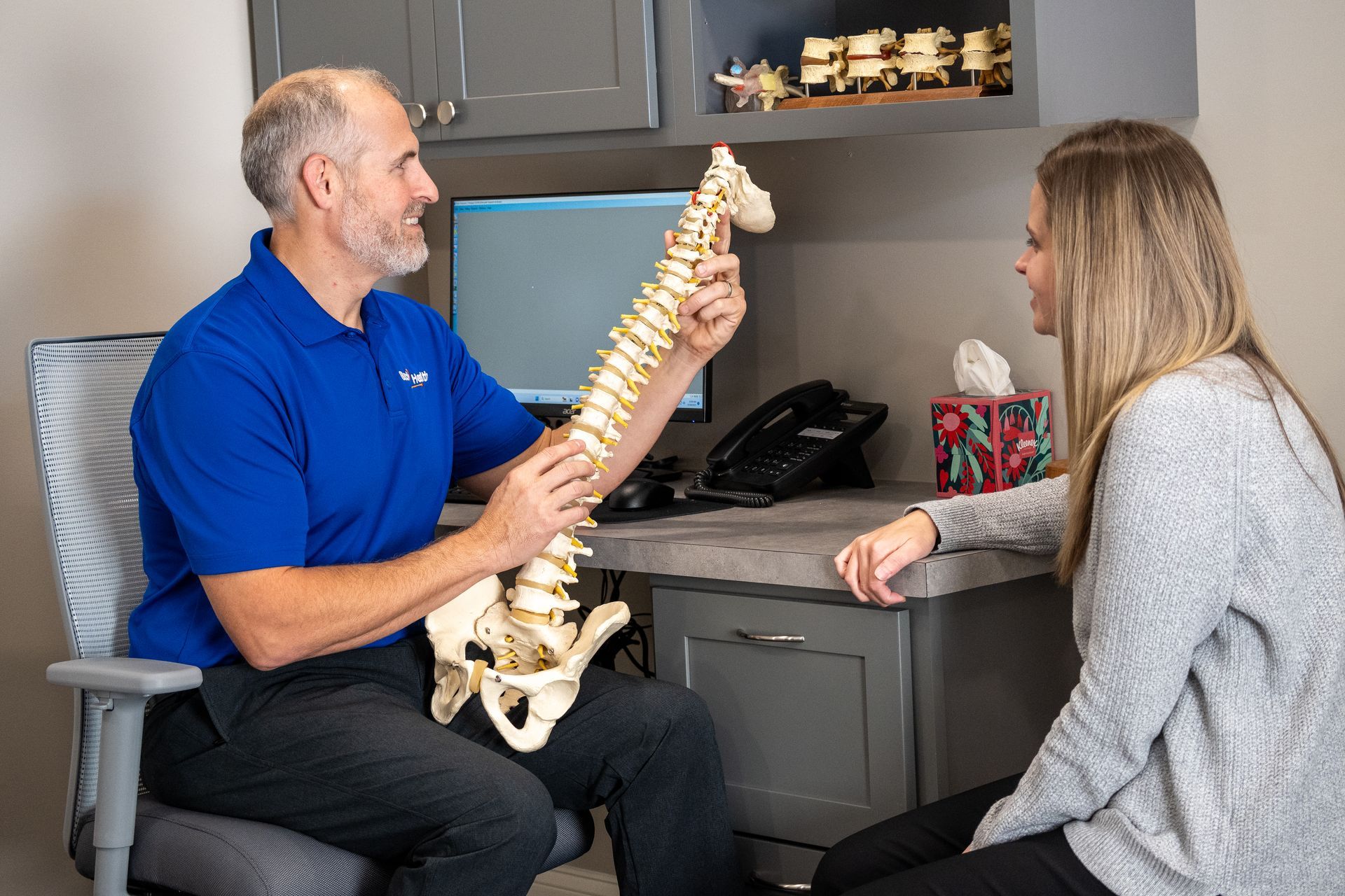 Dr. Nate Laubach explaining part of an appointment to a patient at Back 2 Health