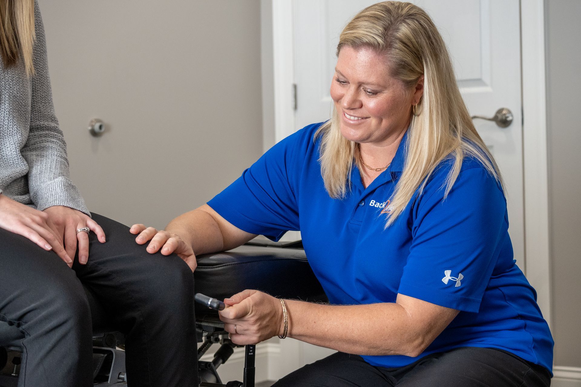 Dr. Elizabeth (Beth) Laubach performing an exam on a patient.