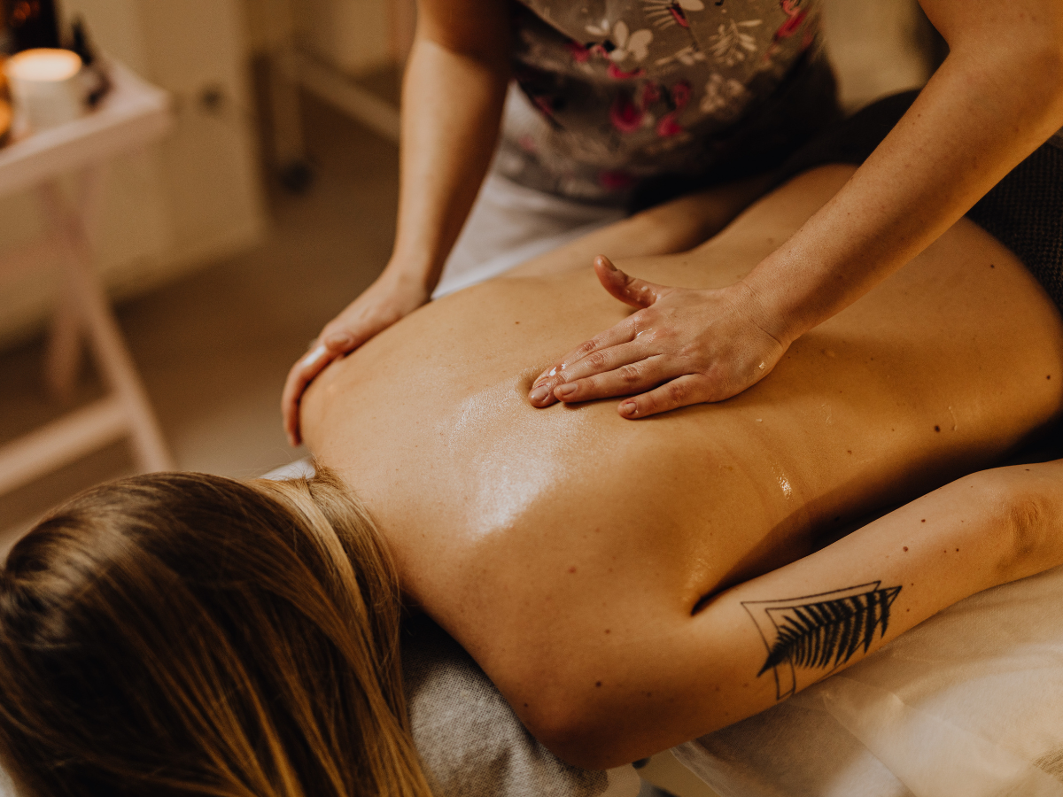 A woman is getting a massage on her back in a spa. A woman is getting a massage on her back in a spa.