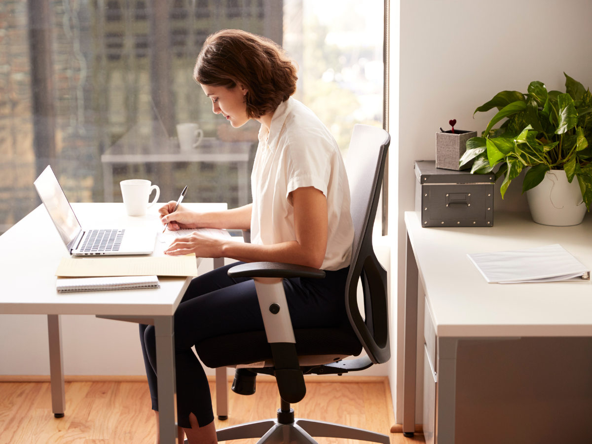 Woman sitting and working on her laptop Woman sitting and working on her laptop