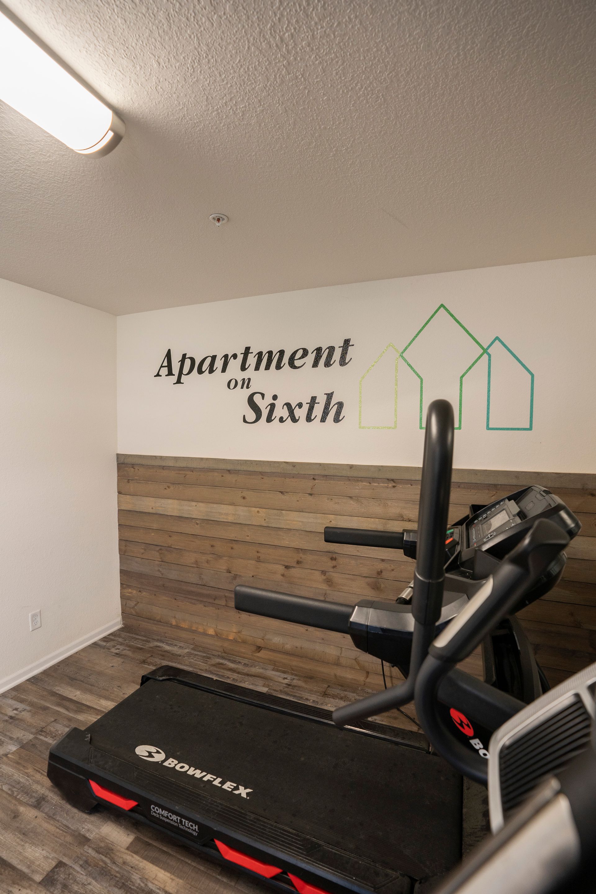 Logo on the wall at apartments on sixth exercise room/gym