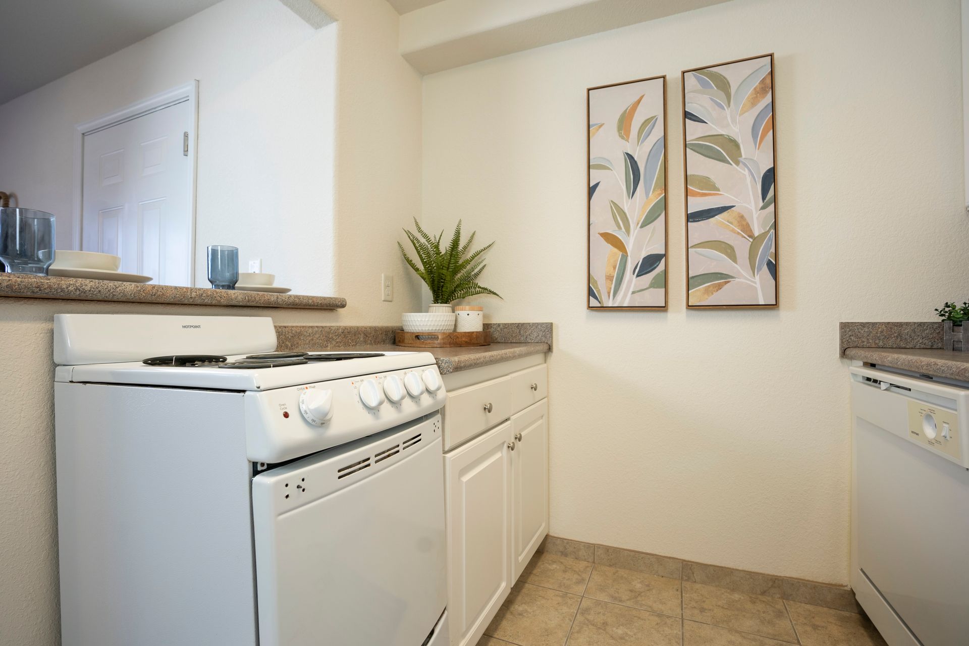 picture of a white kitchen with pretty artwork