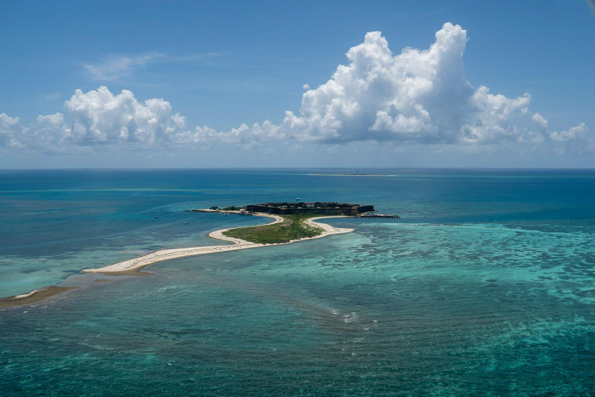 island surrounded by clear blue water