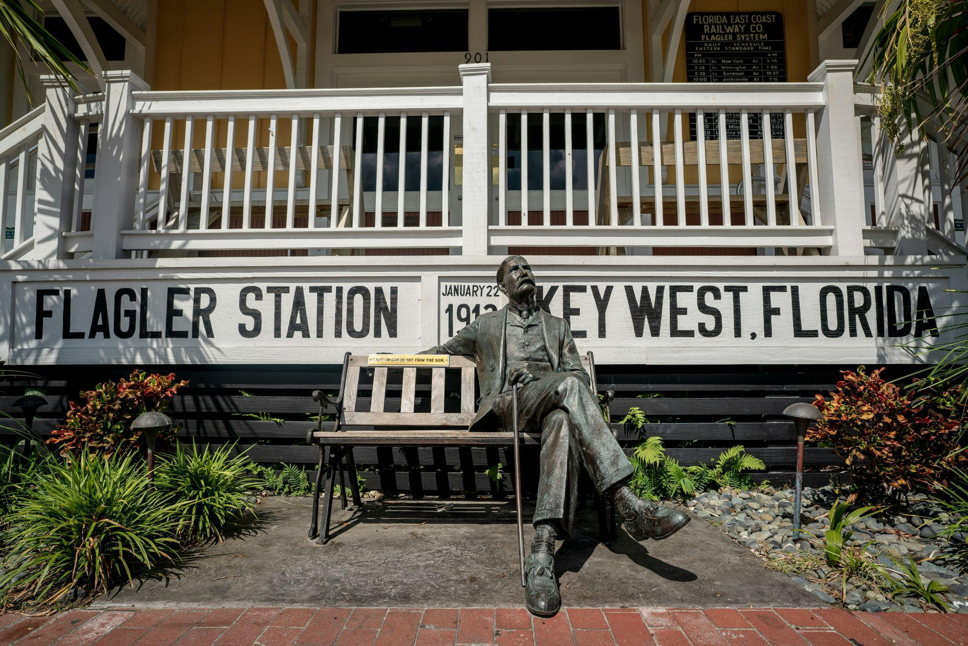 statue of a man sitting on a bench