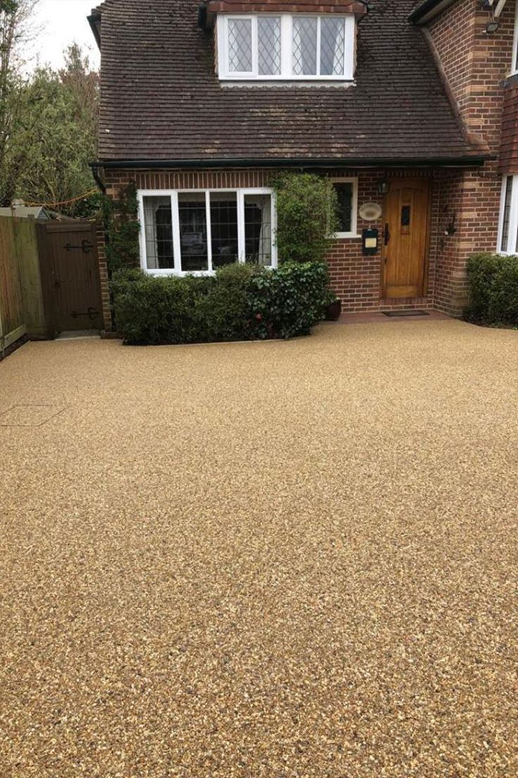 A house with a resin bound gravel driveway in front of it. Installed by Essex Resin driveways