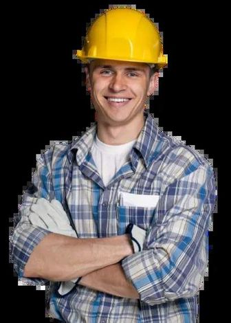 A man wearing a hard hat and plaid shirt with his arms crossed