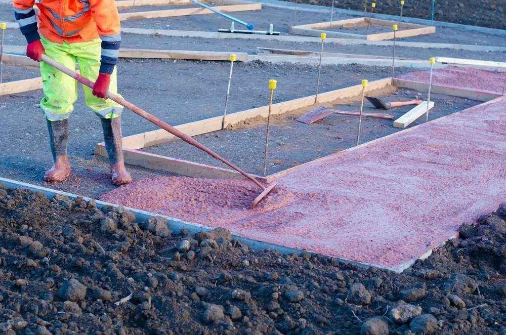 This is a photo of a driveway contractor in Essex Installing resin bound pathways on a construction site in Essex.