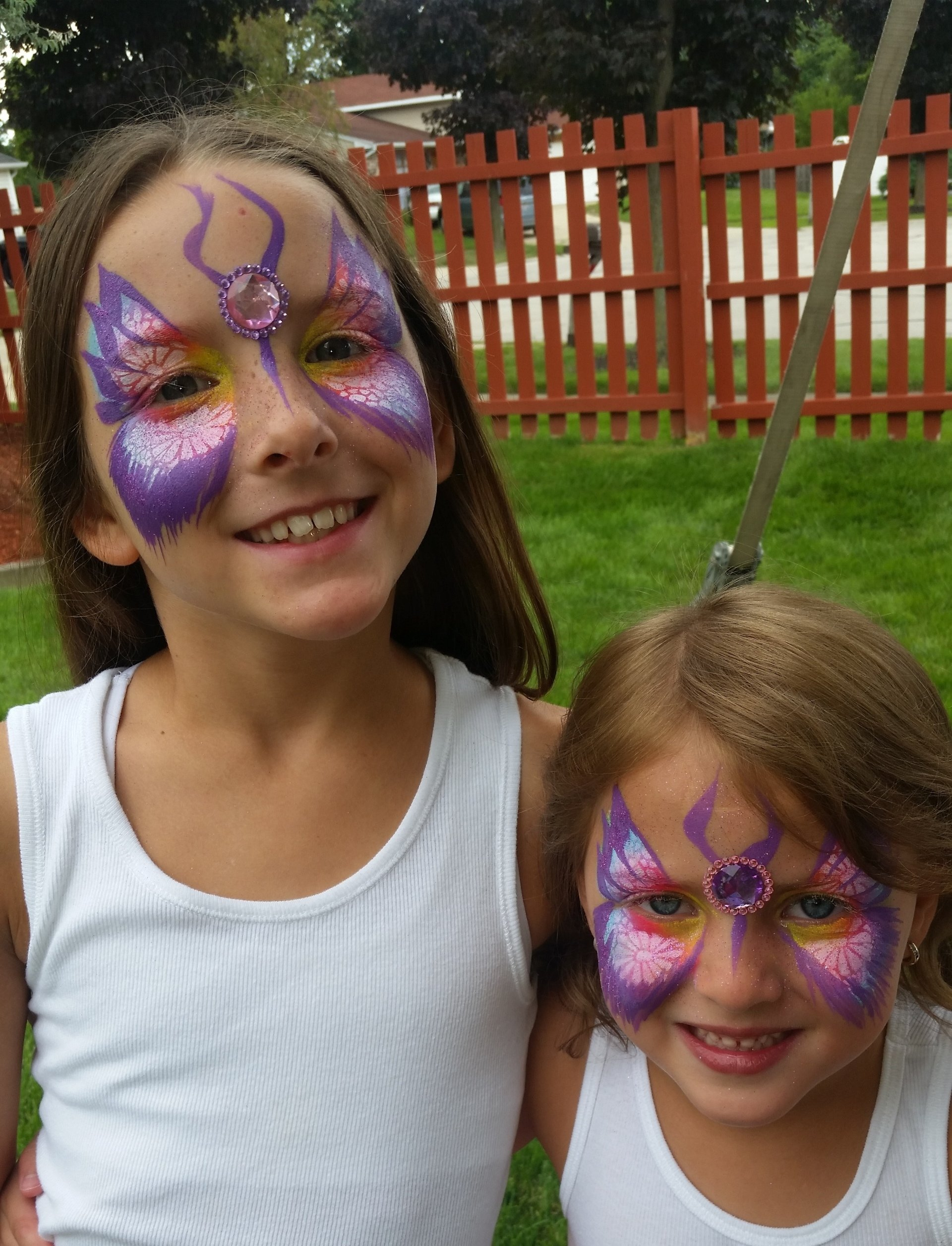 kid party chicago face painting little girls face painted with gems