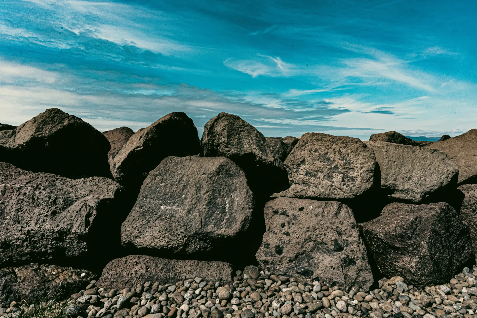 Close-up of large natural stones, commonly used in construction and building materials. The stones represent quarry-sourced raw materials like crusher run, vital for construction projects.