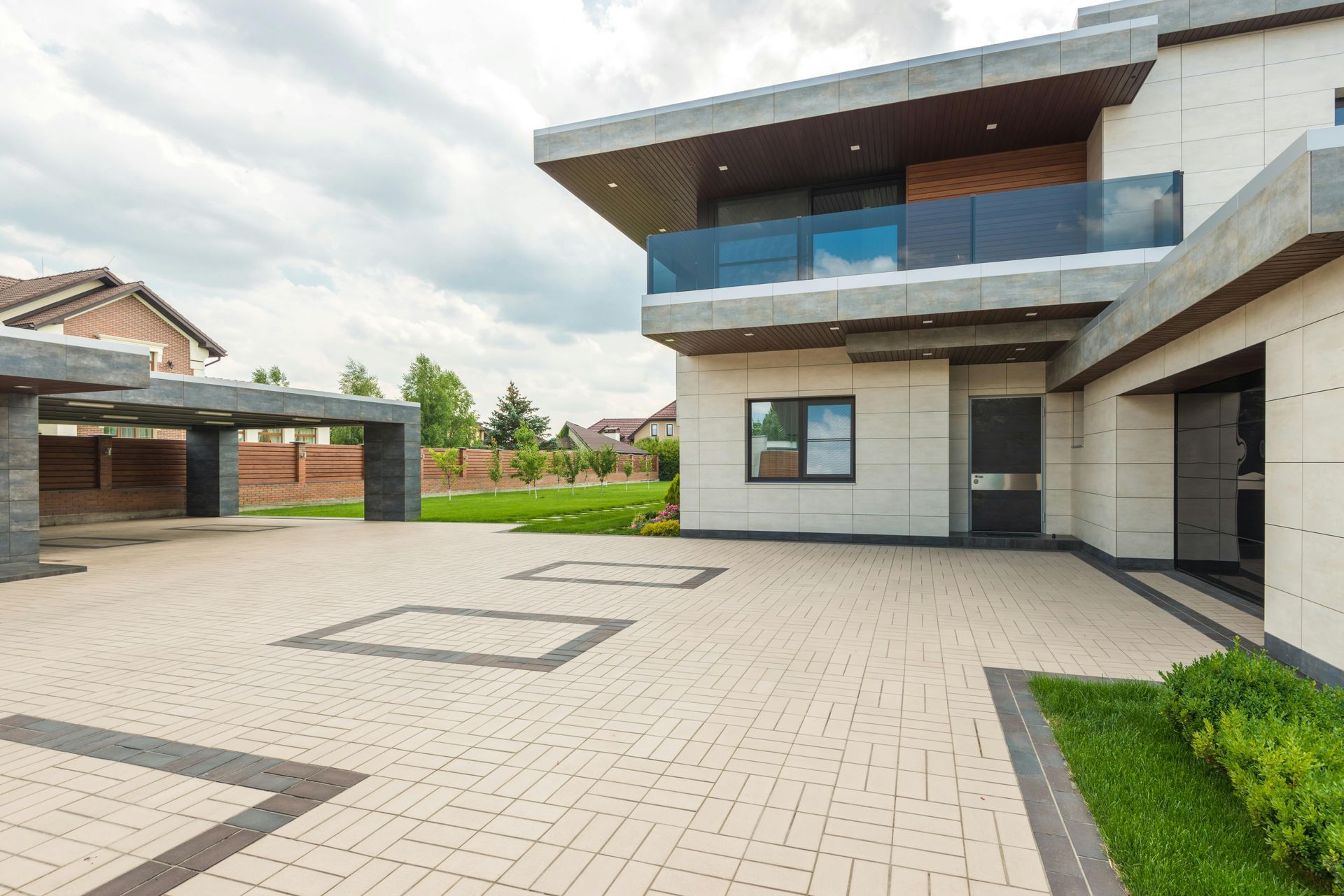 Modern house exterior with paved driveway, garage, and landscaped yard