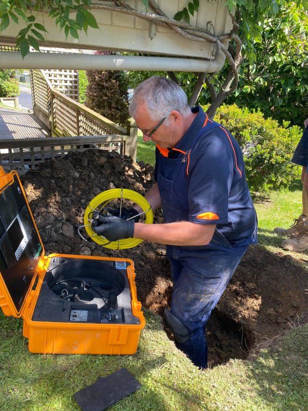 Expert plumber Mike Mains  inspecting a drainage using drain camera