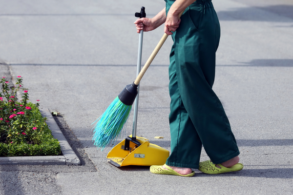 Using a broom when cleaning sidewalks