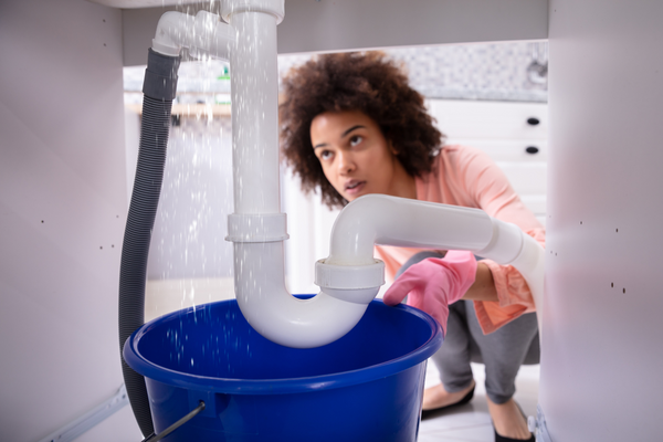 a woman checking for water leaks