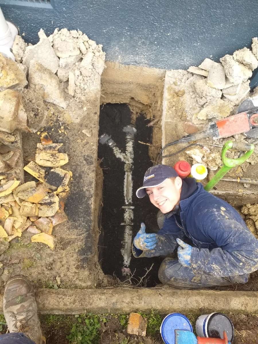 plumber setting up a ground drainage