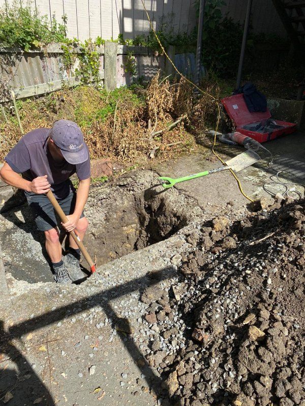 master plumber preparing ground drain laying set up