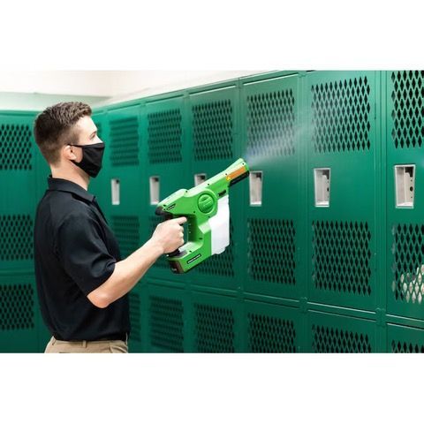 Two men are cleaning an office with a vacuum cleaner.
