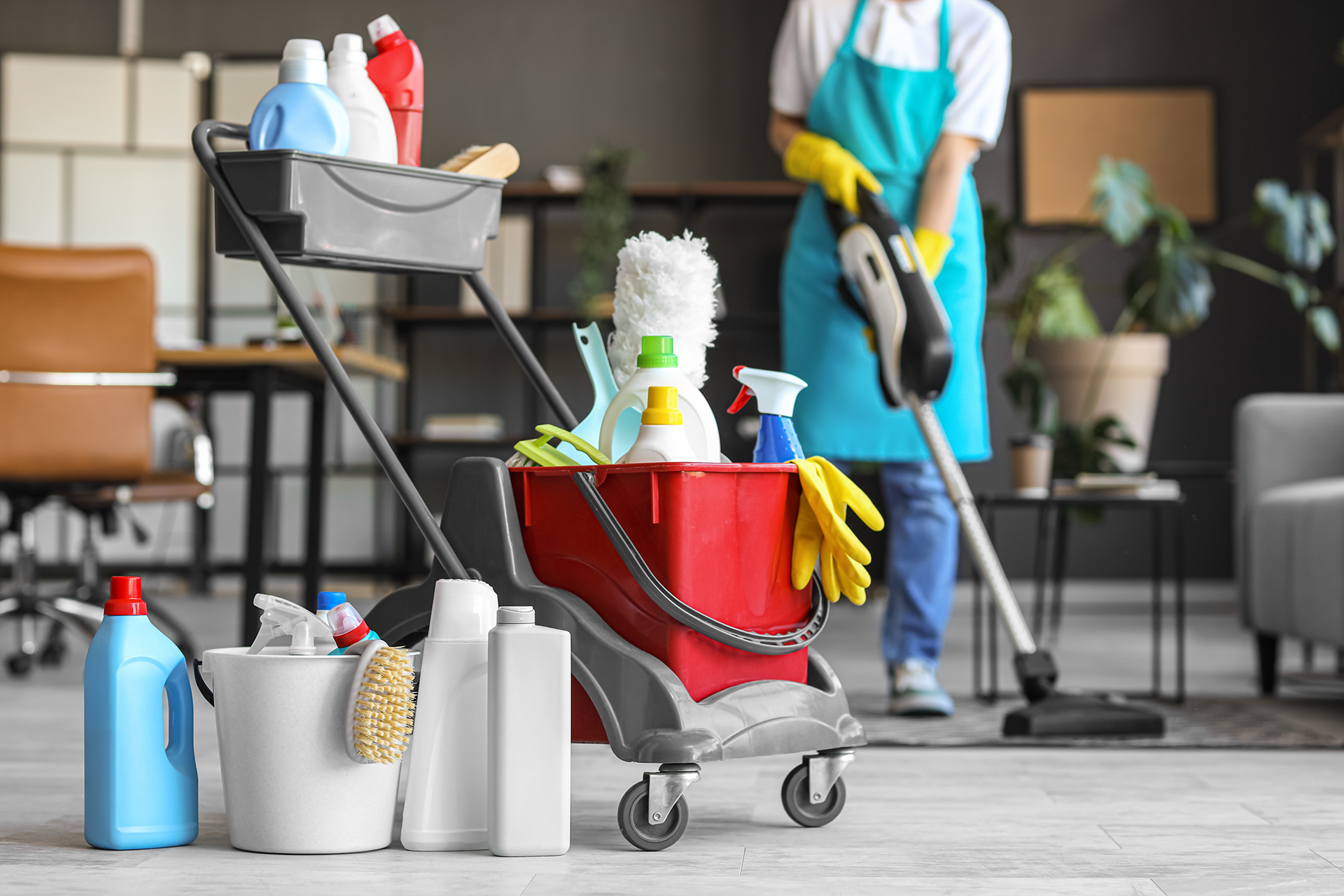 A woman is cleaning a room with a vacuum cleaner.