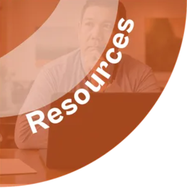 A man sitting in front of a laptop with the words resources written around him