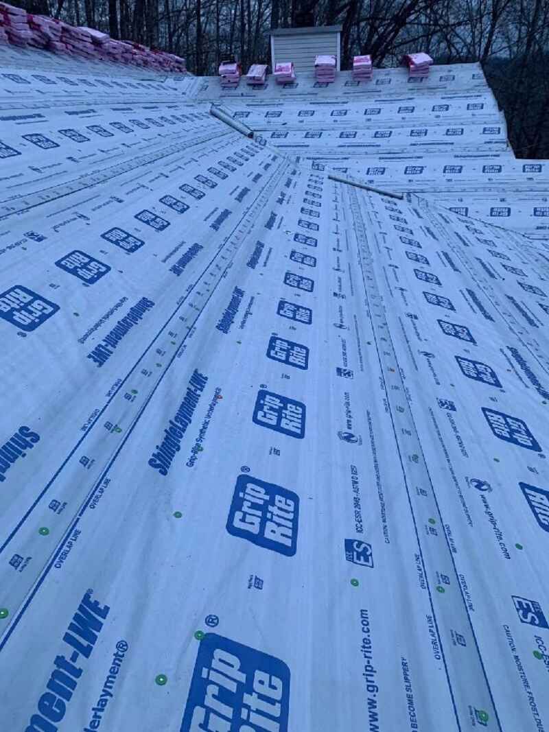 A roof with a lot of roofing material on it.