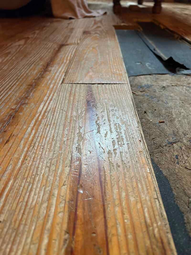 A close up of a piece of wood on a wooden floor.