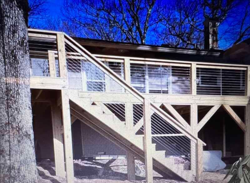 A wooden deck with stairs leading up to it