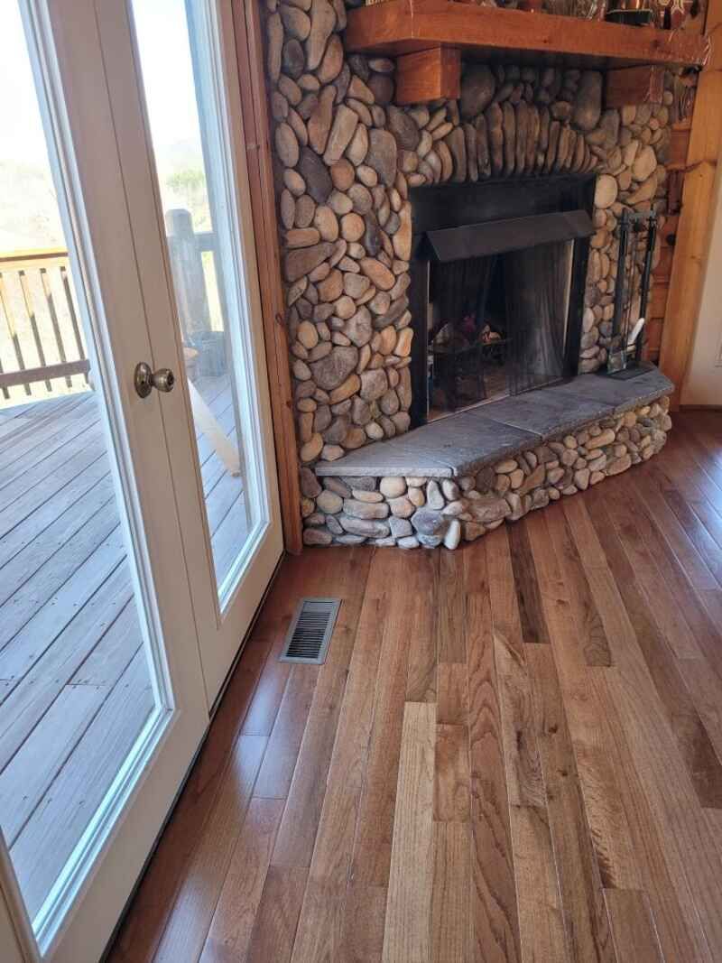 A living room with a fireplace and sliding glass doors.