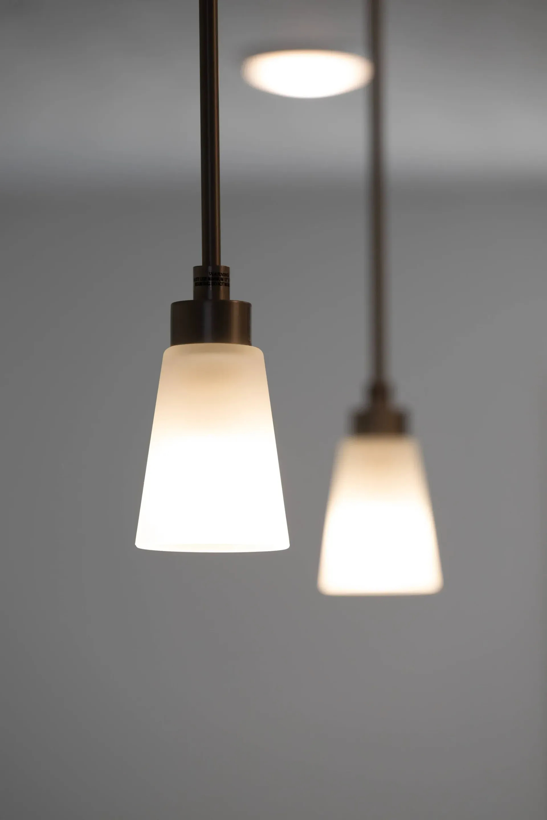 Close-up of two pendant lights hanging from the ceiling.