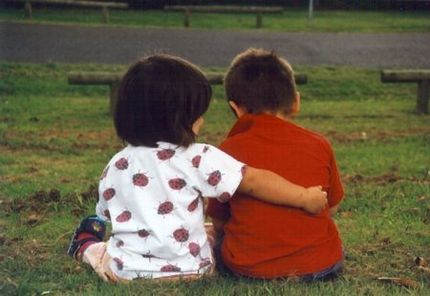 young kids sitting next to eachother