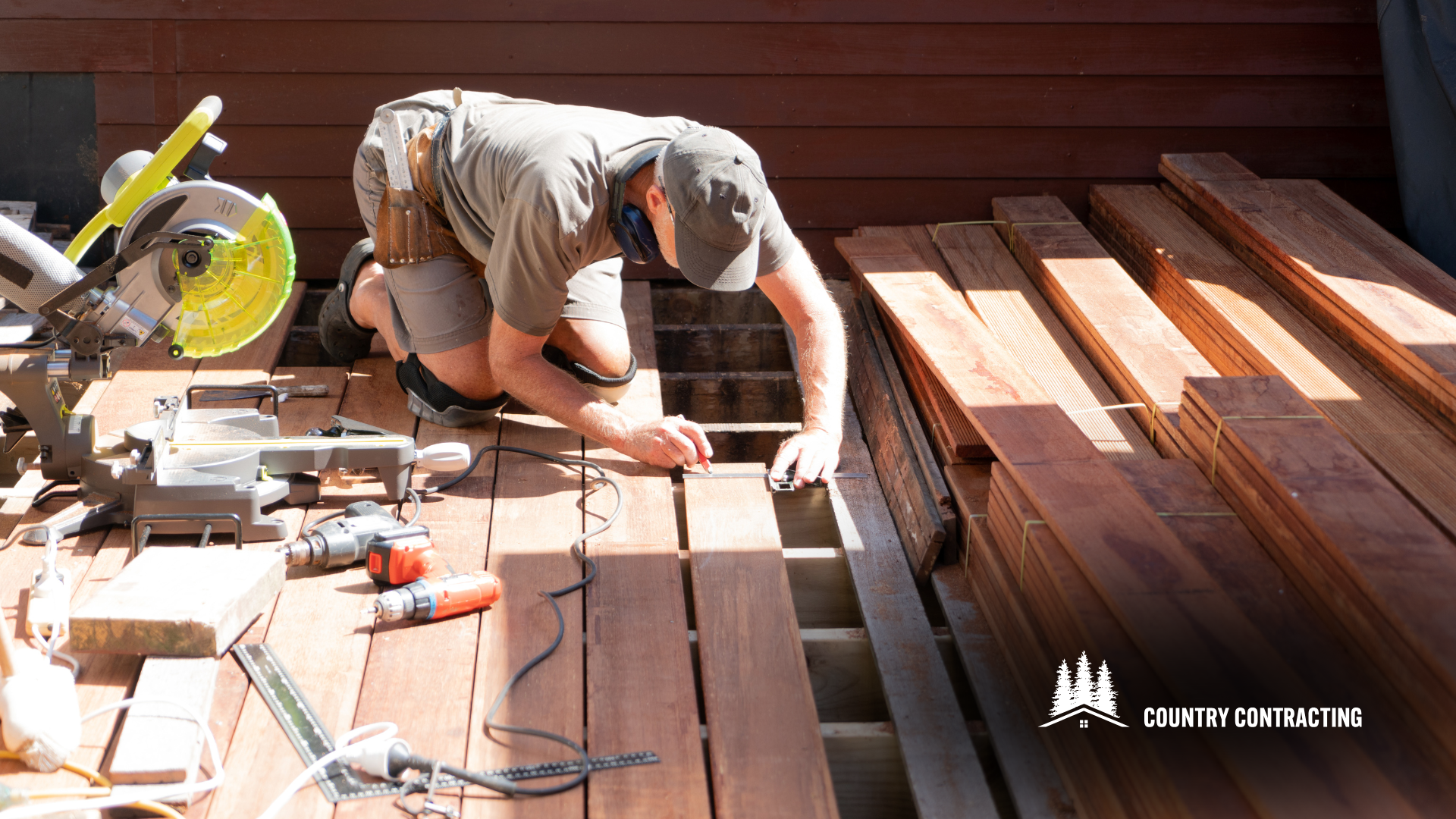 A man is working on a wooden deck with a circular saw.