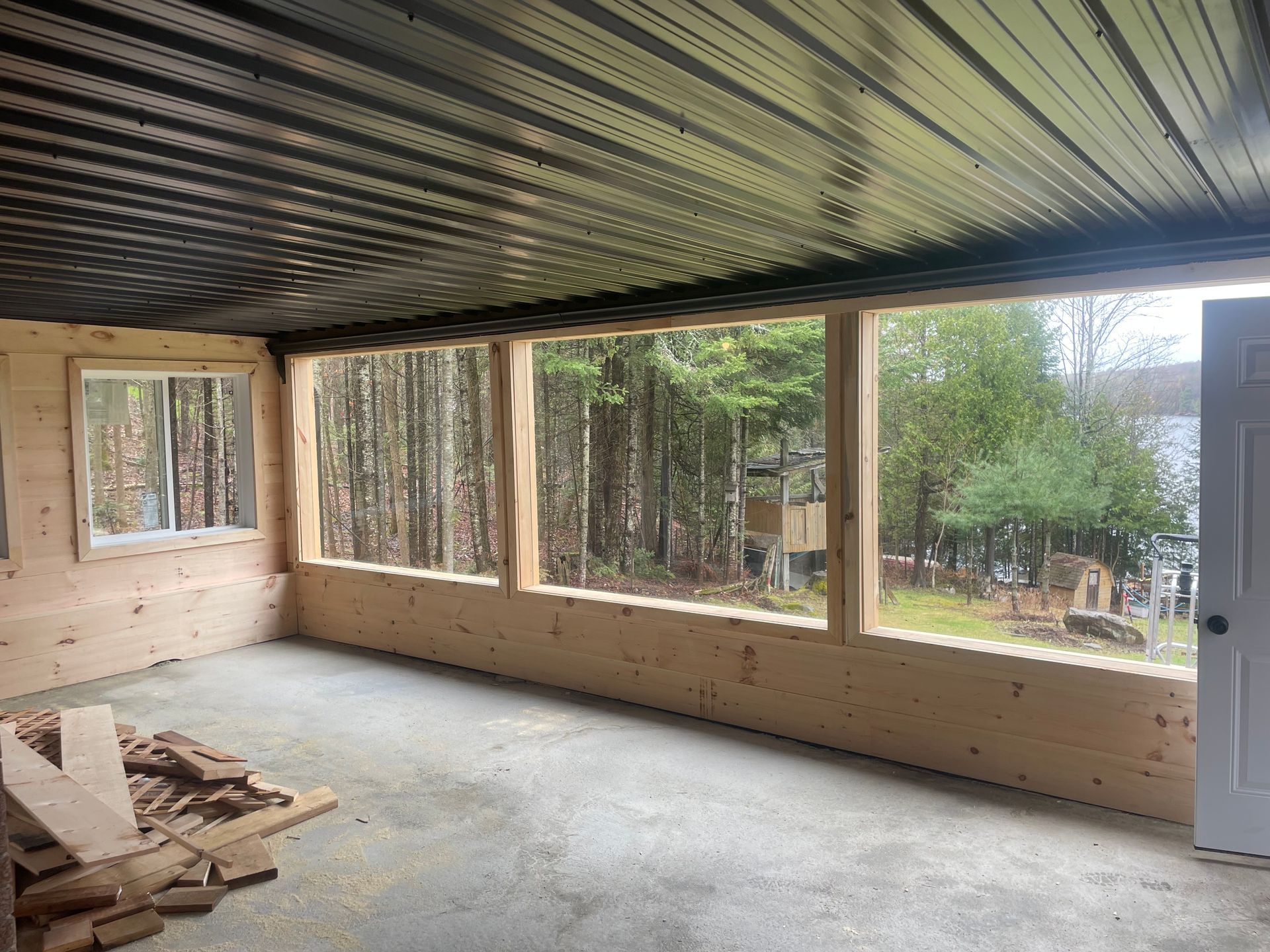 A room with a lot of windows and a wooden wall.