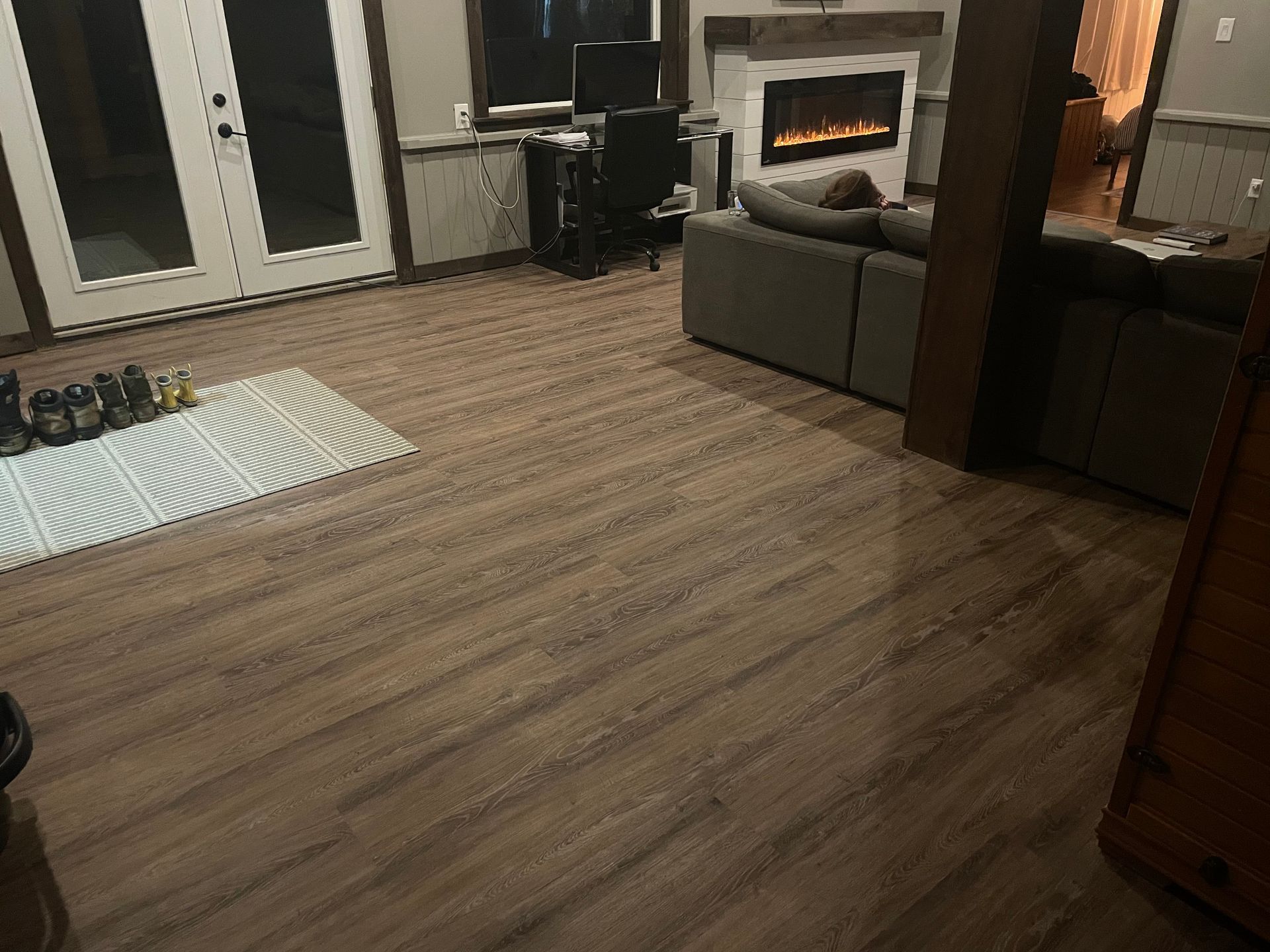 A living room with hardwood floors and a fireplace.