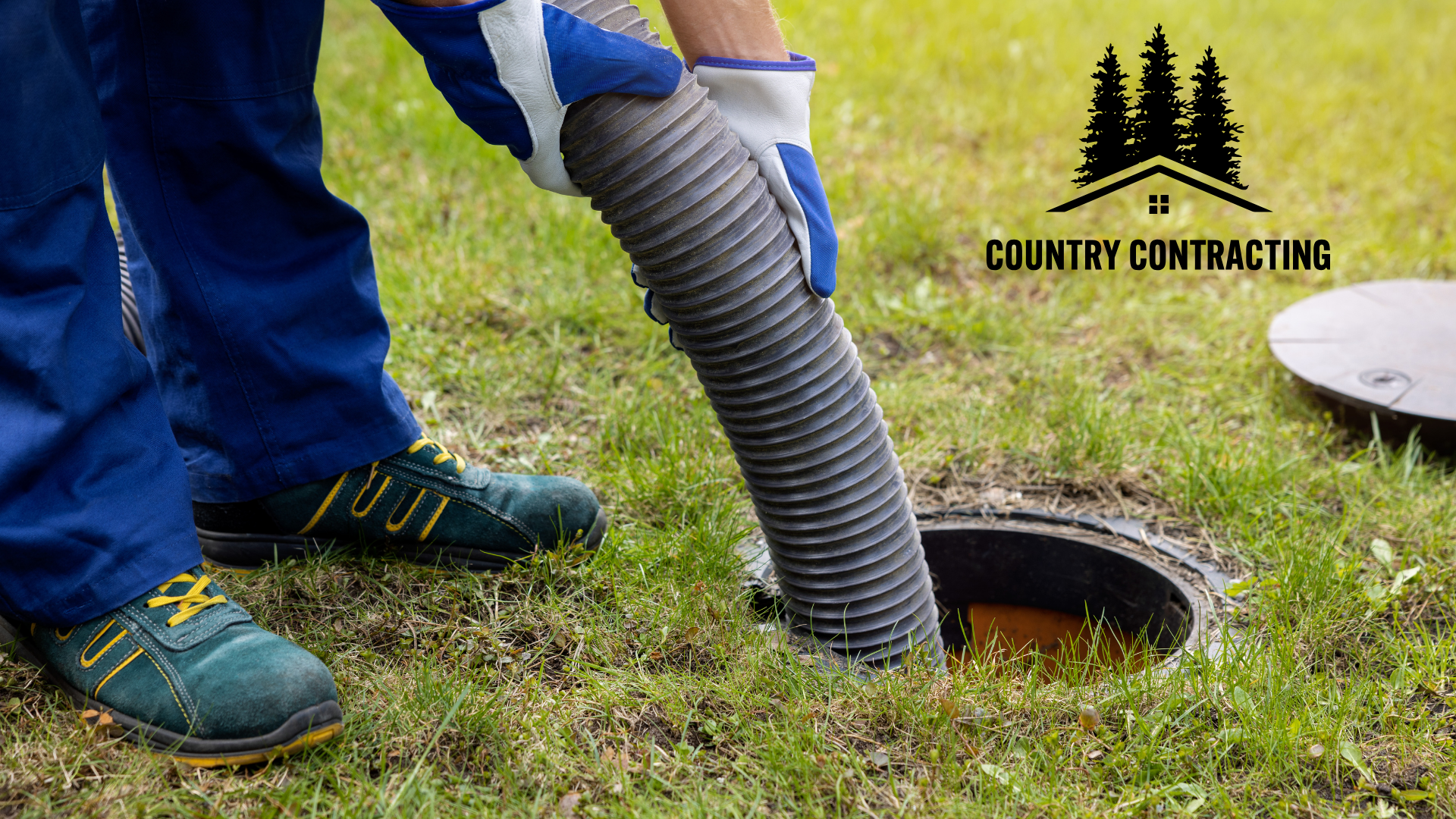 A man is pumping a septic tank with a vacuum hose.