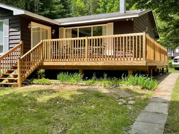 A house with a large wooden deck and stairs