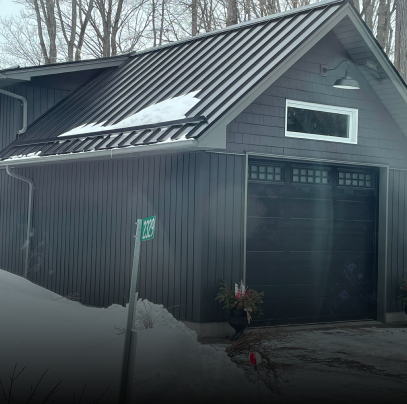 A black garage with a metal roof and a sign that says 1 159