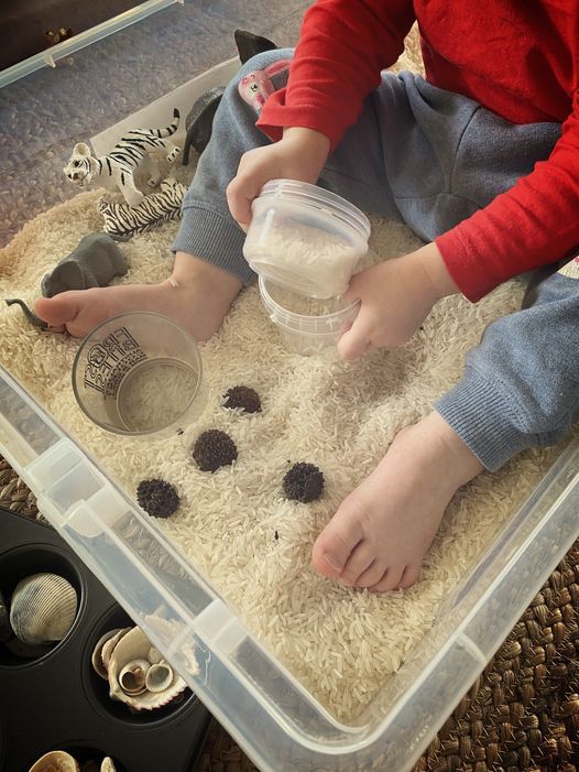Child playing with rice — The Happy Human Hub