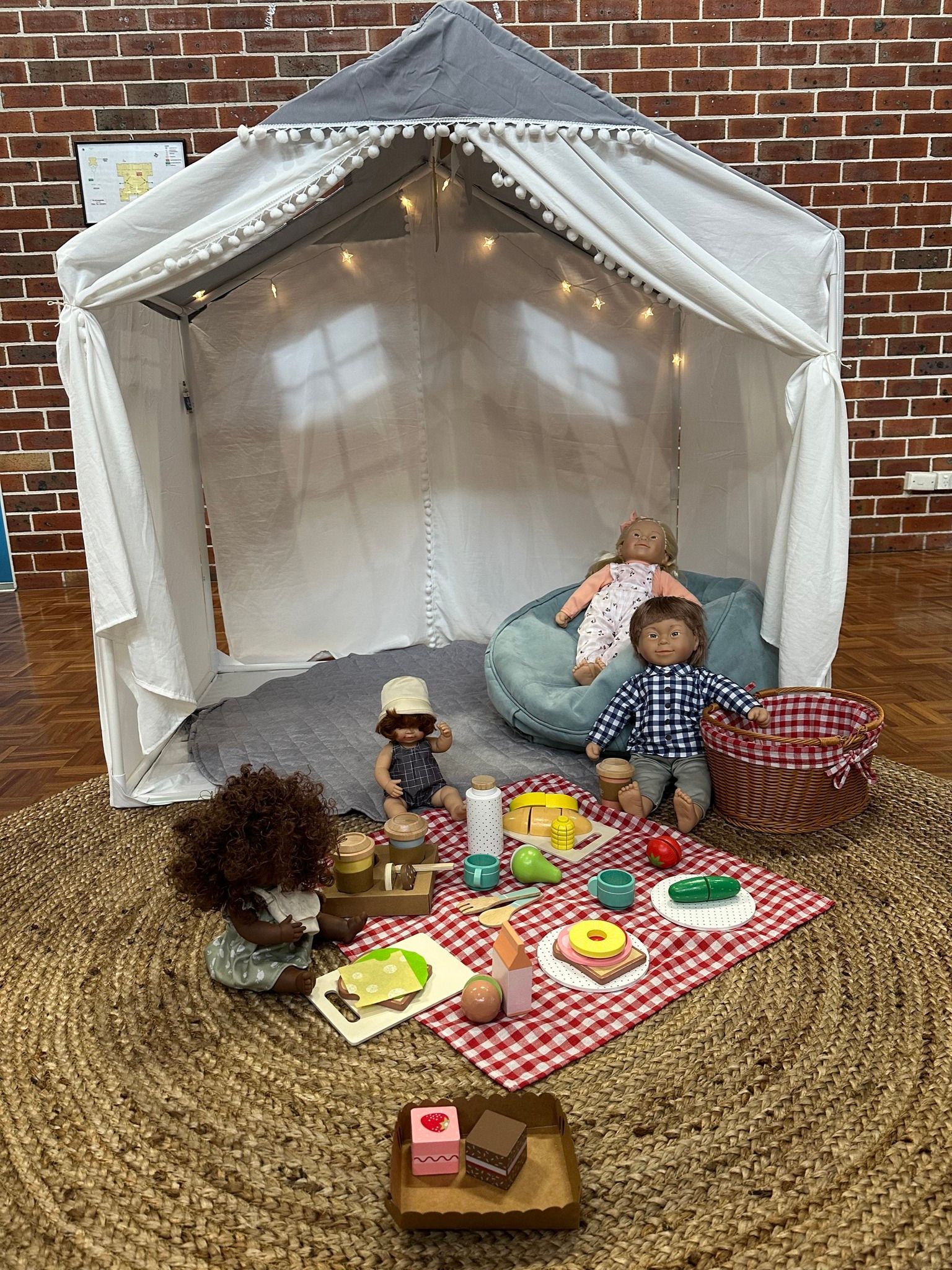 Children's play room with dolls on a picnic rug — The Happy Human Hub