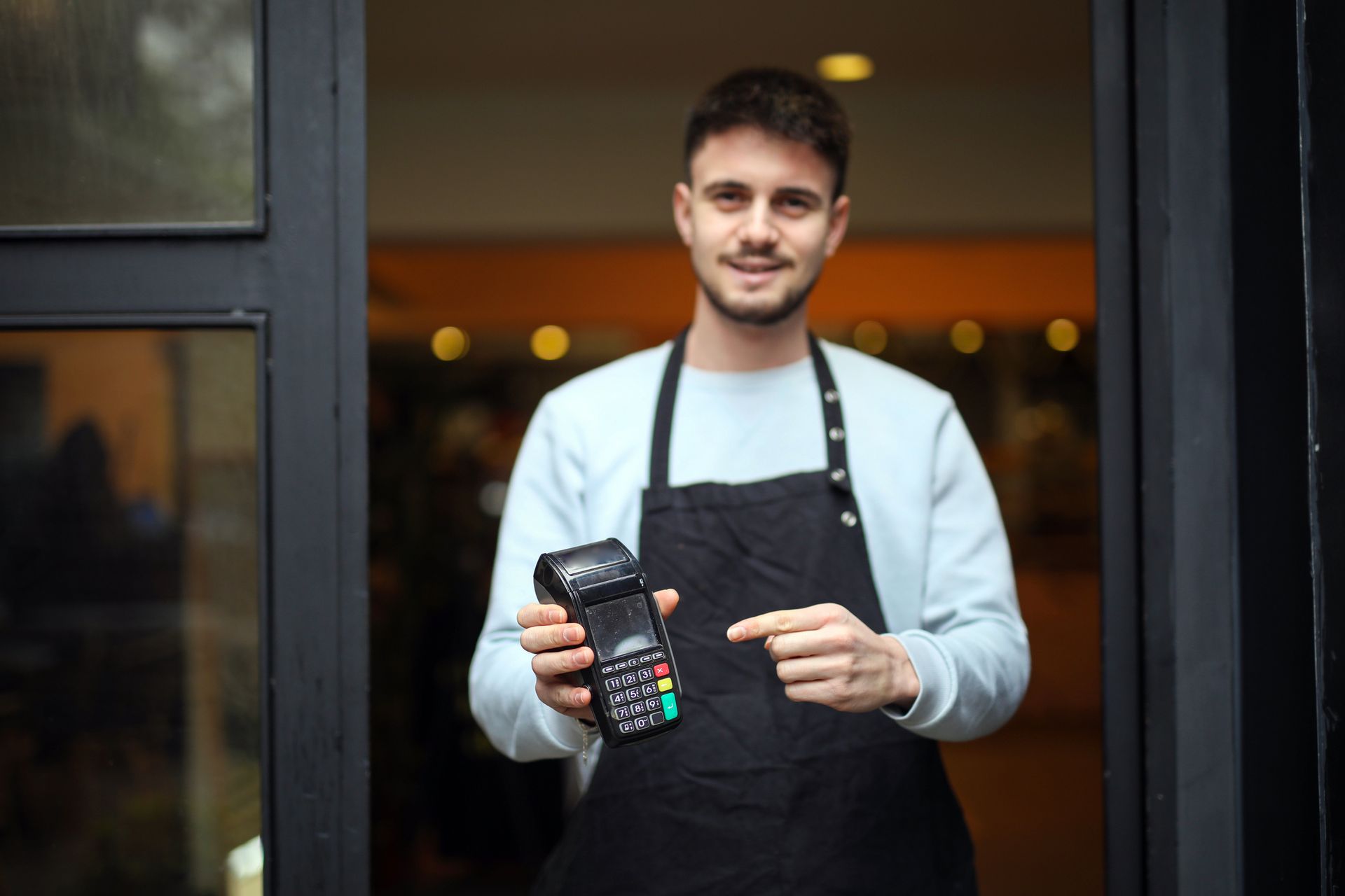 Man Holding Credit Card System - Flint, MI - Caretek Total Business Concepts 