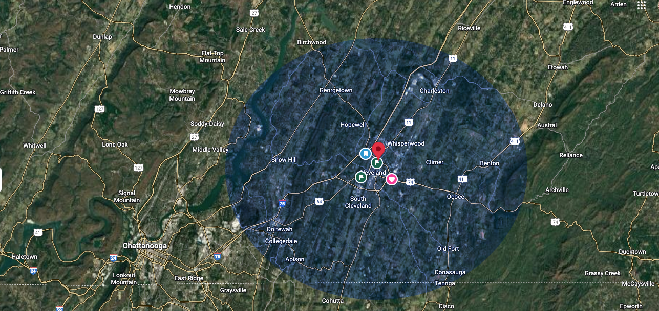 Aerial view of a city center with a blue circle overlay, possibly indicating a geographic area of interest.