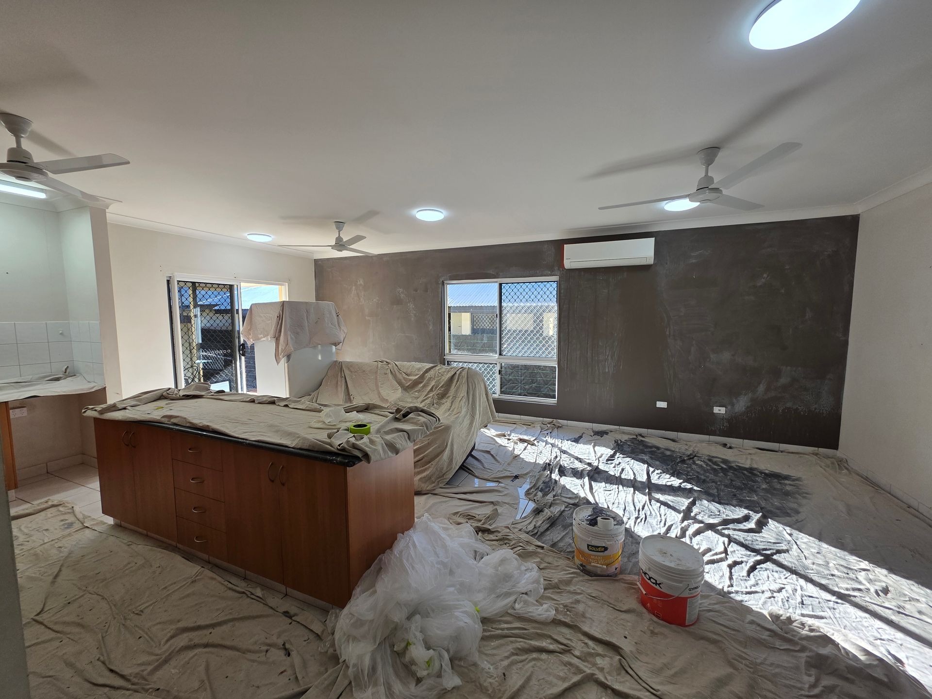 White Corrugated-iron Clad Building With Air Conditioning Unit — Prestige Painting NT in Zuccoli, NT