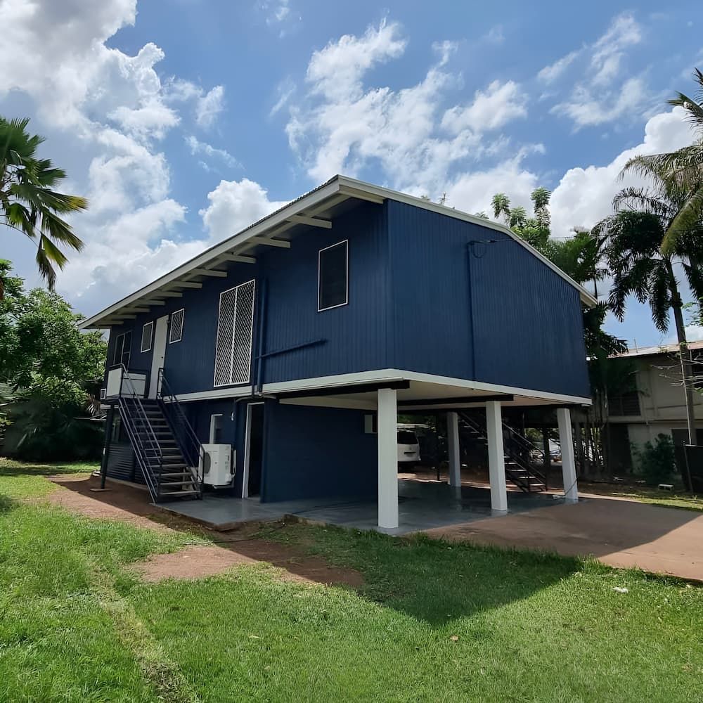 Blue Elevated House With White Supports and Stairs — Prestige Painting NT in Zuccoli, NT