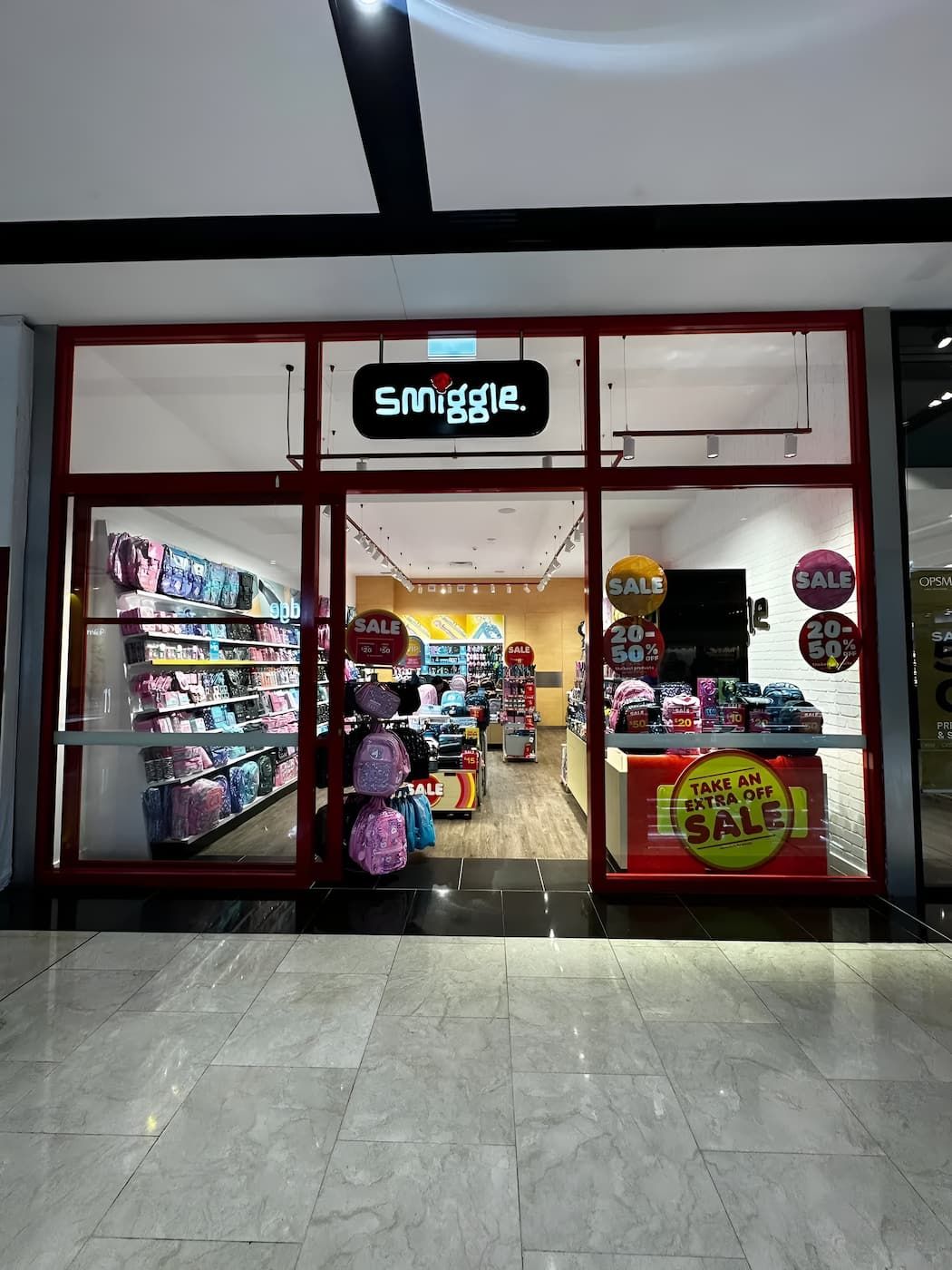 Smiggle Store Front With Red Frame, Offering Colourful Stationery and Bags — Prestige Painting NT in Zuccoli, NT