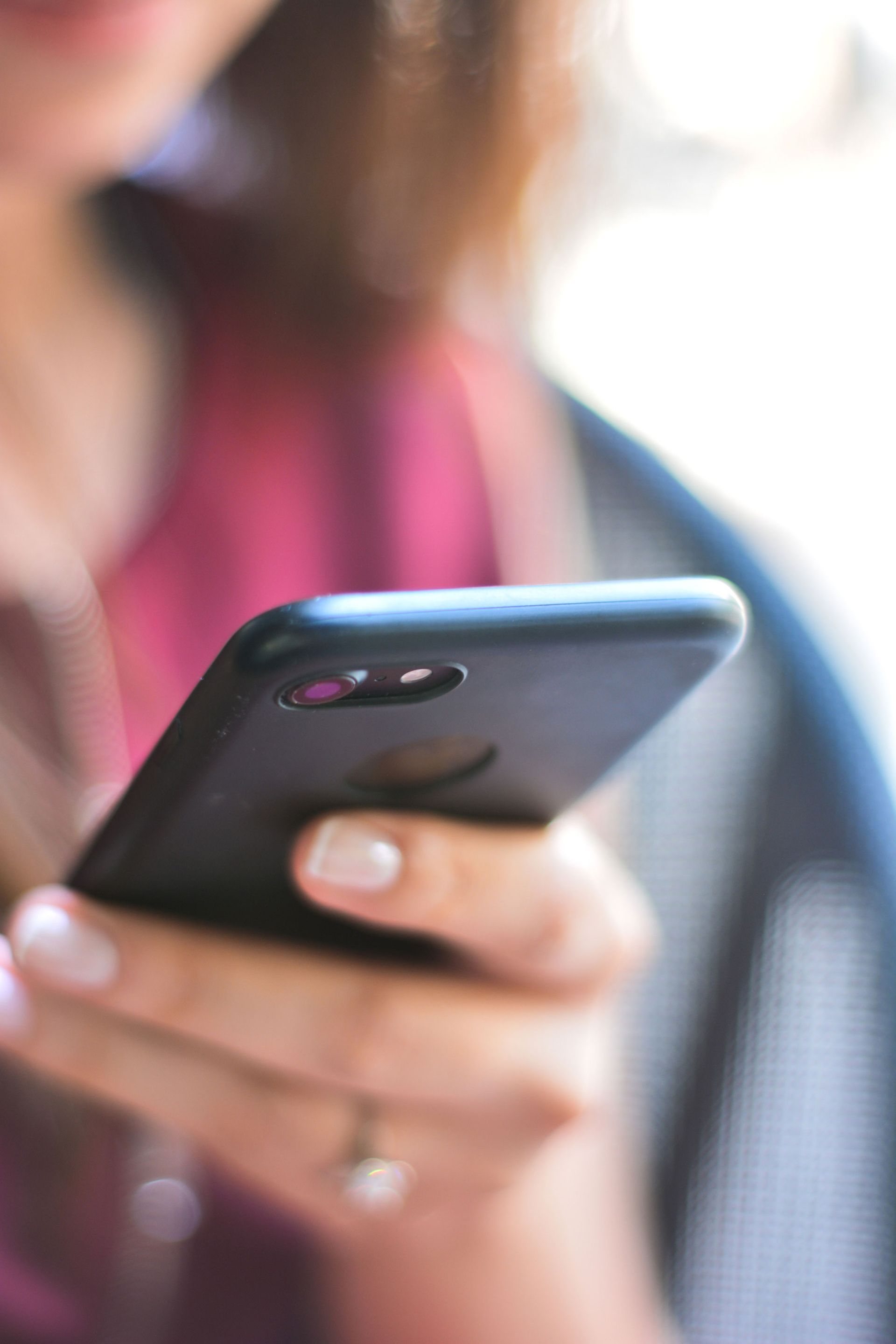 photo of person using cellphone - click to contact us