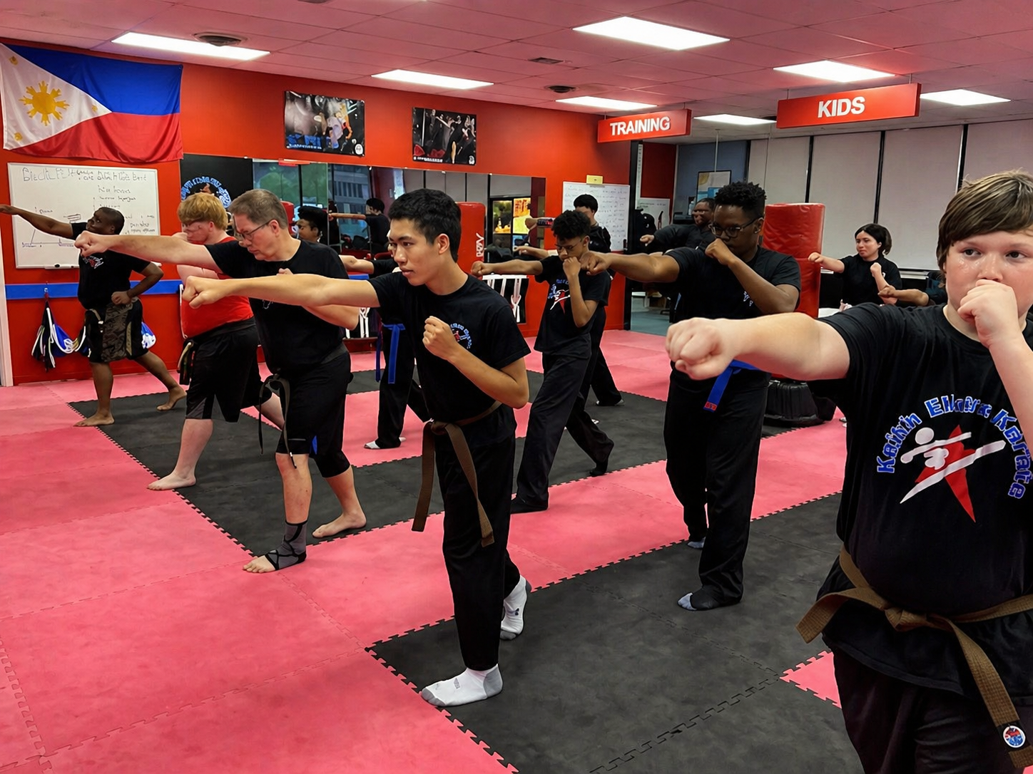 Two people practicing Brazilian Jiu-Jitsu on a mat. One is on top, applying a hold.