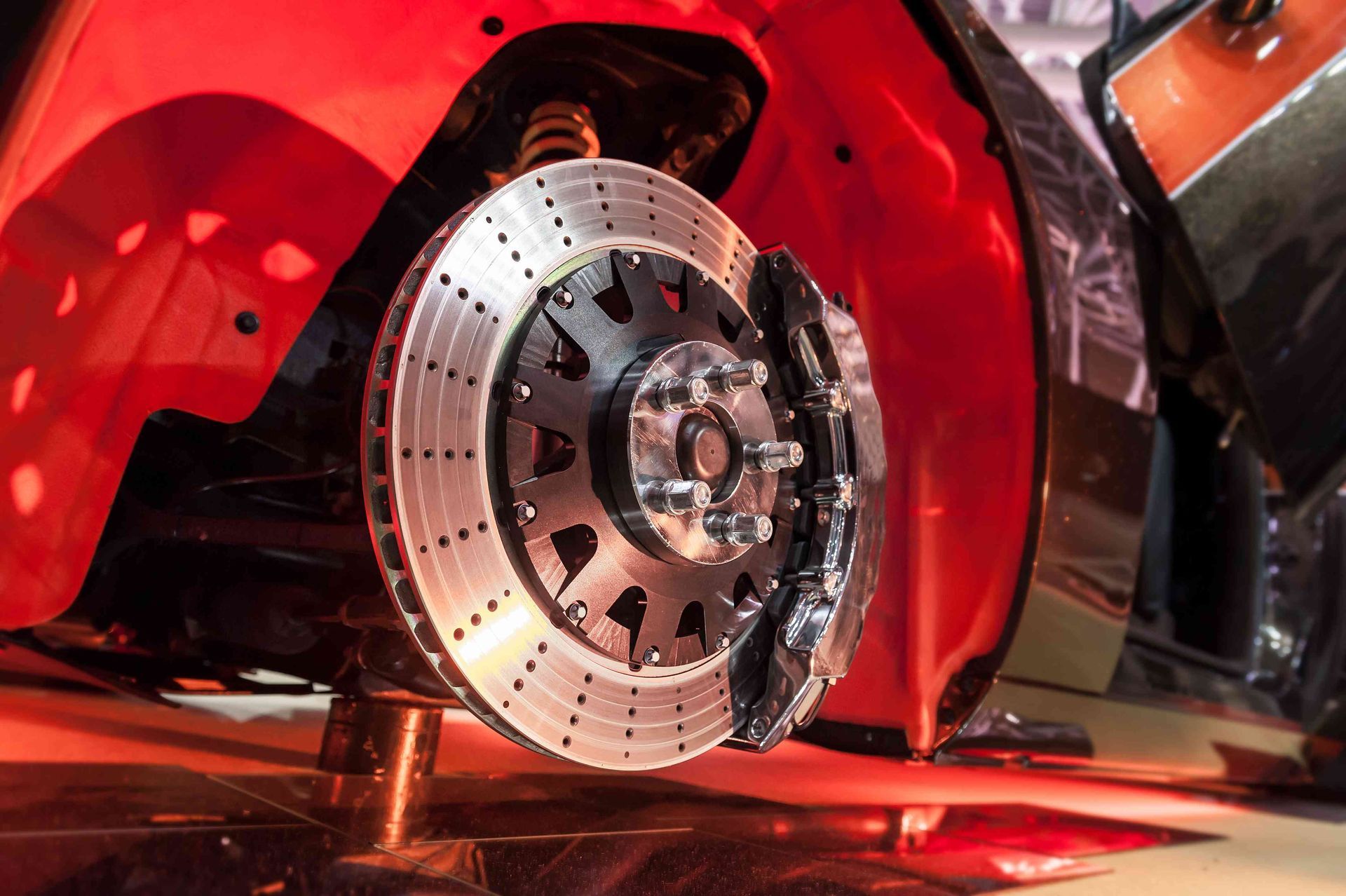 a close up of a brake disc on a red car