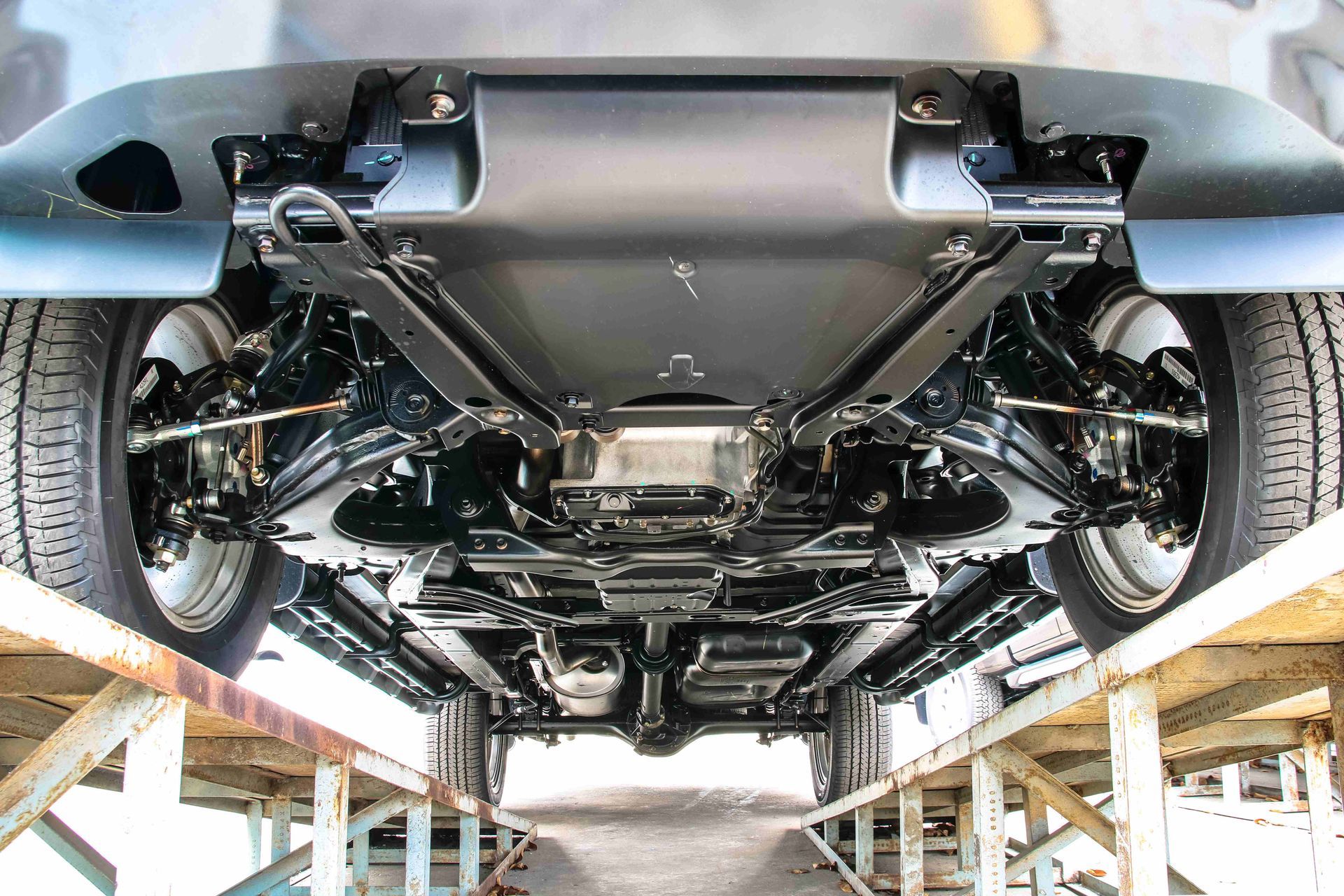 the underside of a car is shown on a lift