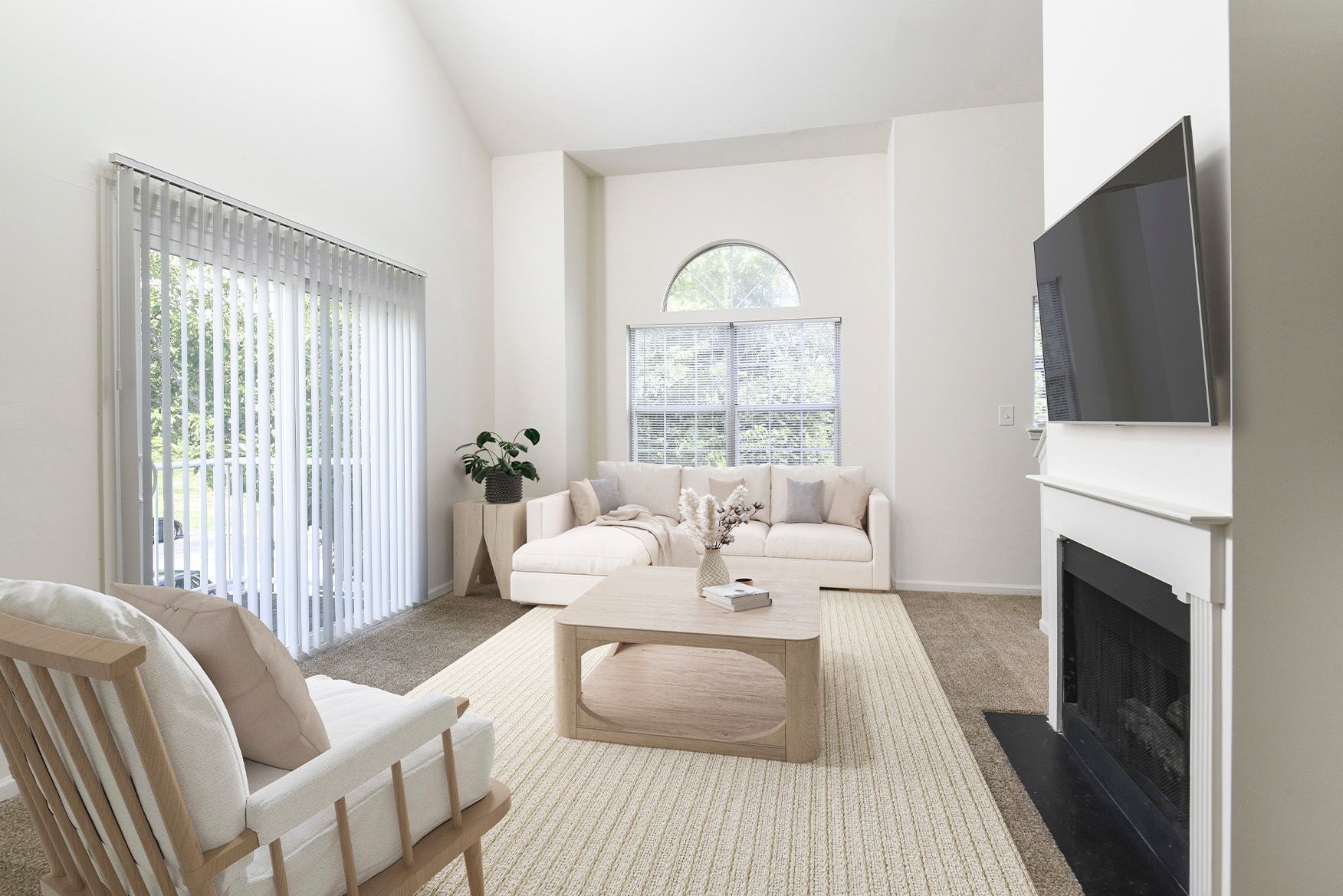 Bright living room with beige sofa, wood coffee table, fireplace, and wall-mounted TV.