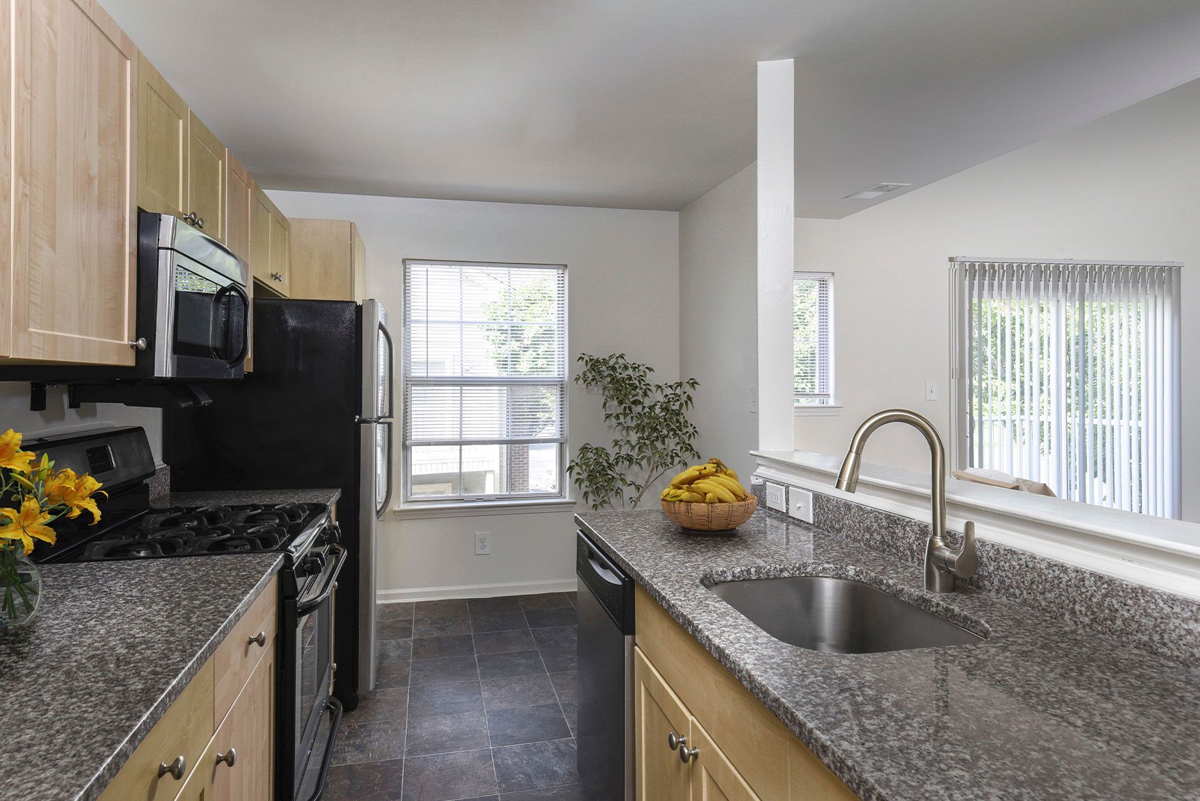 Kitchen with granite countertops, stainless steel appliances, and an island.