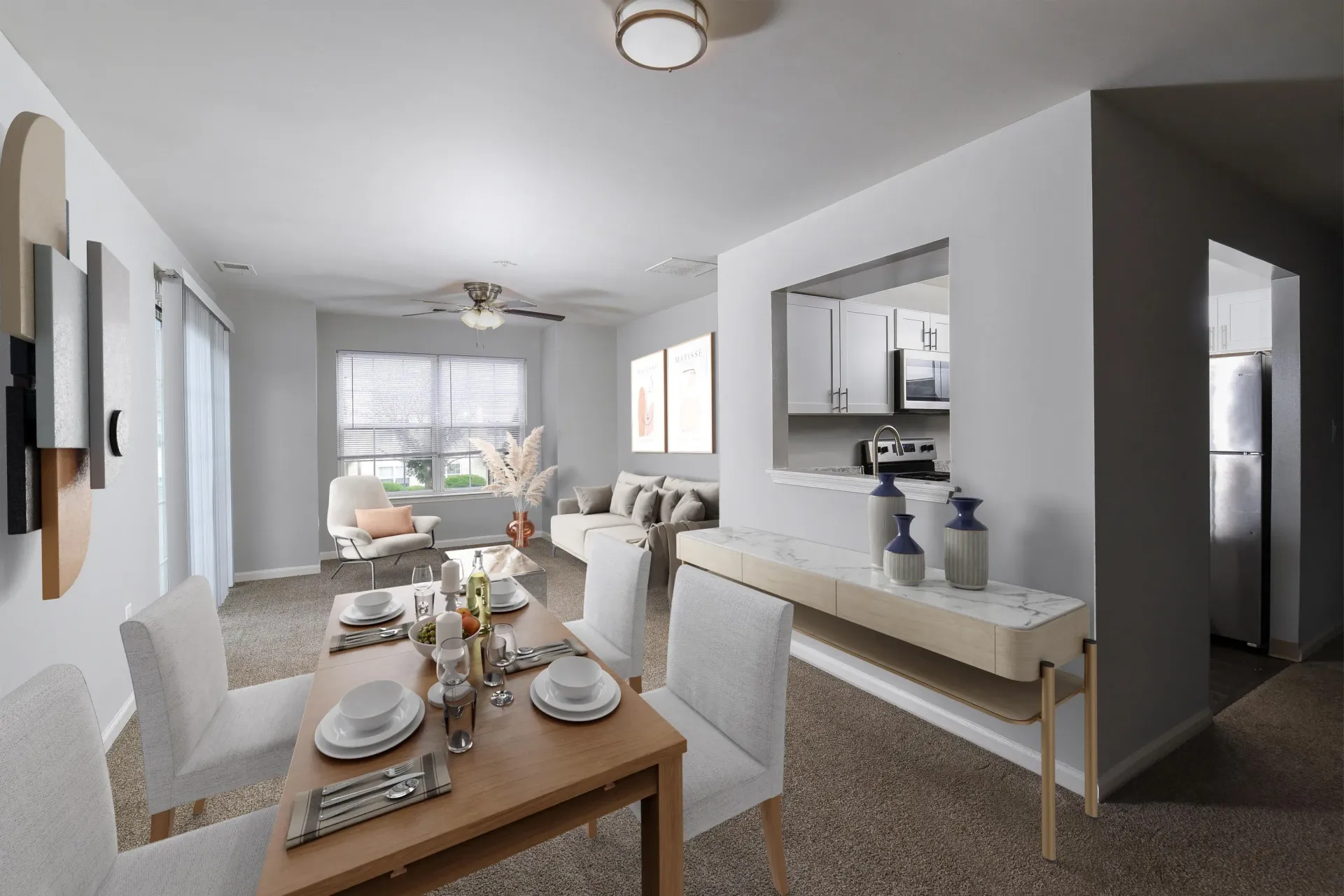 Open-plan living and dining area in a modern apartment with a kitchen pass-through.