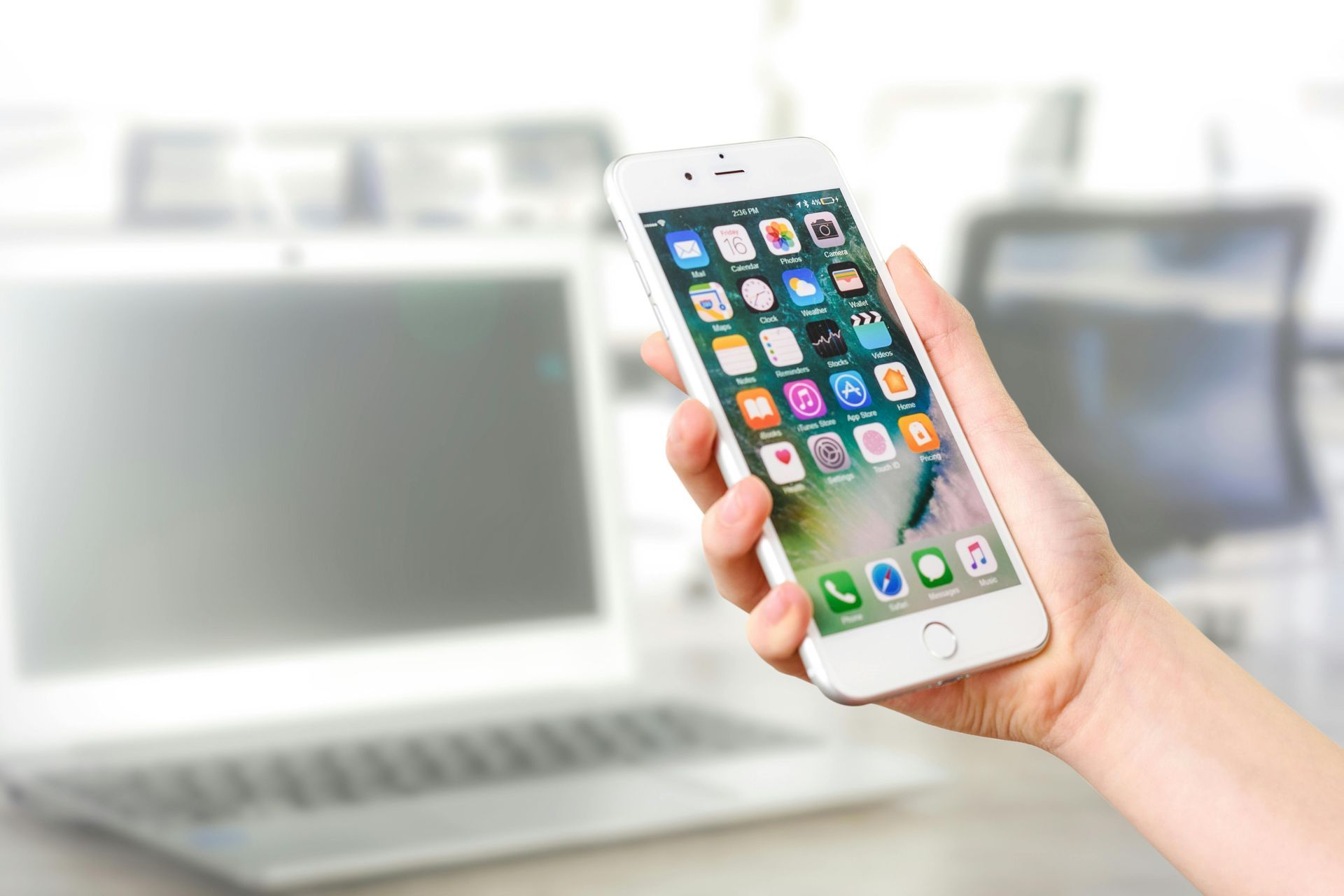 Person holding phone with apps